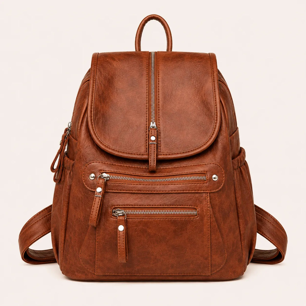 Sac à dos femme marron effet cuir vintage avec multiples poches zippées et rabat sur fond beige #F6F0ED