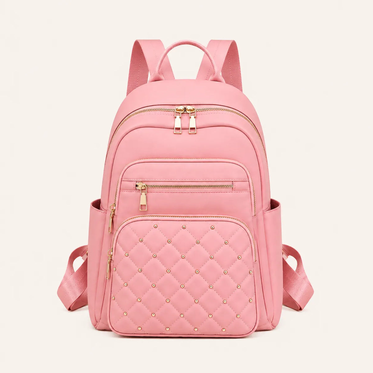 Sac à dos femme rose matelassé avec détails dorés et poches zippées vu de face