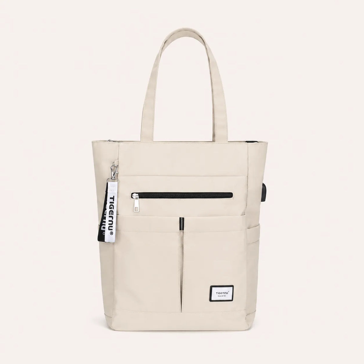 Sac ordinateur femme beige TIGERNU avec multiples poches extérieures, fermeture zippée et grande capacité de rangement pour ordinateur portable.